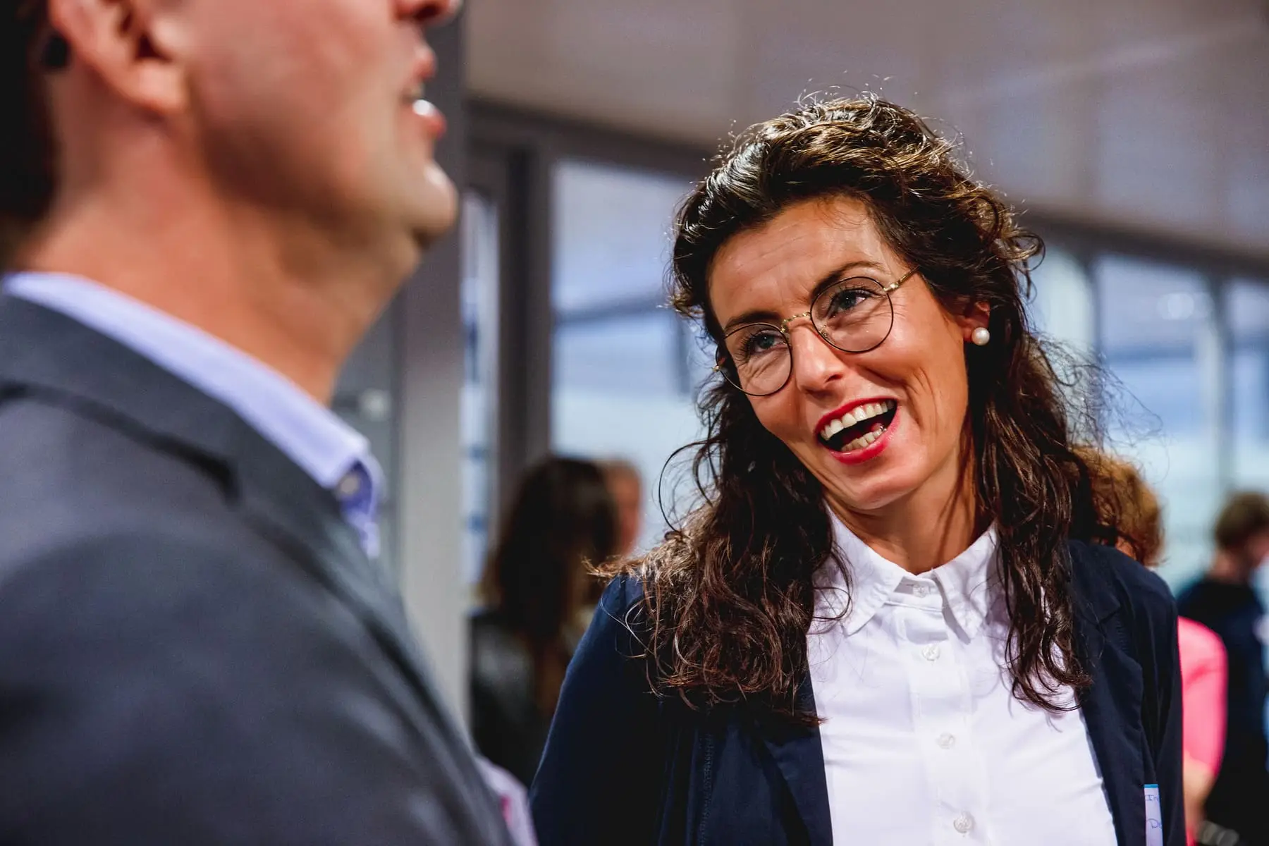 A founder laughing mid-conversation at a Next Women gathering